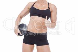 Female athlete holding discus and showing thumbs up