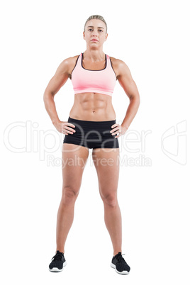 Female athlete posing with hands on hip