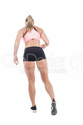 Female athlete posing with hands on hip