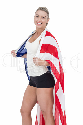 Female athlete with american flag on her shoulders