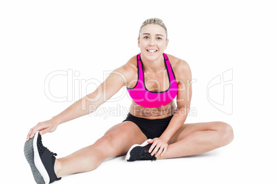 Female athlete sitting and stretching