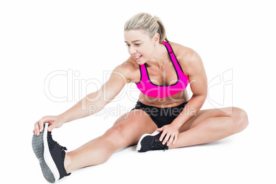 Female athlete sitting and stretching