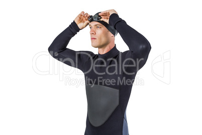 Swimmer in wetsuit wearing swimming goggles