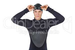 Swimmer in wetsuit wearing swimming goggles