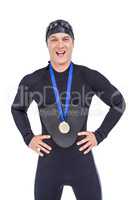 Victorious swimmer posing with gold medal around his neck