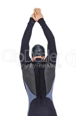 Rear view of swimmer in wetsuit while diving