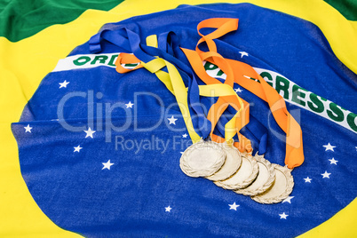 Close-up of gold medals on brazilian flag