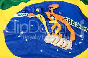 Close-up of gold medals on brazilian flag