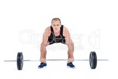 Bodybuilder lifting heavy barbell weights