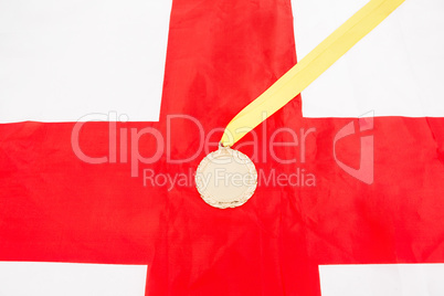 Close-up of gold medal on english flag