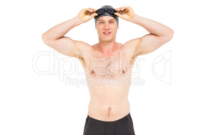 Portrait of swimmer holding swimming goggles