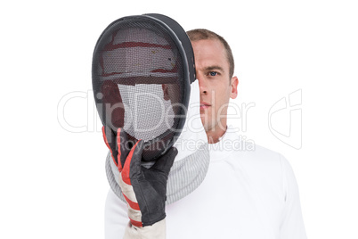 Swordsman holding fencing mask