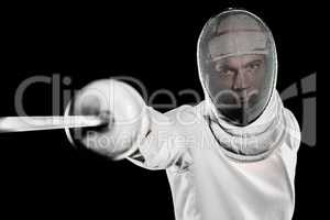 Man wearing fencing suit practicing with sword