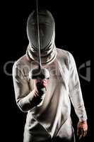 Man wearing fencing suit practicing with sword