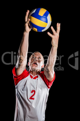 Sportsman catching a volleyball while playing