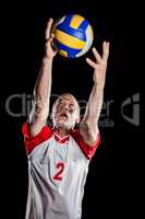 Sportsman catching a volleyball while playing