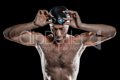 Swimmer holding swimming goggles