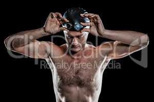 Swimmer holding swimming goggles