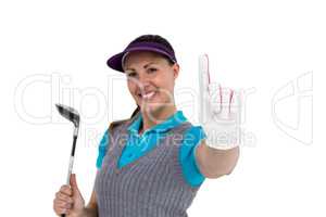 Golf player posing with golf club