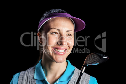 Golf player holding golf club on black background