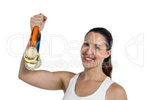 Female athlete posing with gold medals after victory