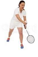 Female athlete holding a badminton racquet ready to serve