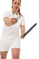 Female athlete holding a badminton racquet ready to serve