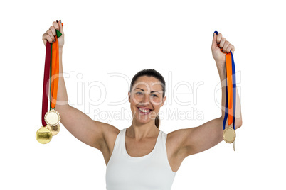 Female athlete posing with gold medals after victory