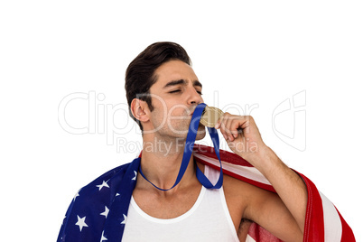 Athlete kissing gold medal after victory