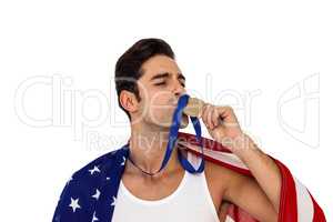 Athlete kissing gold medal after victory