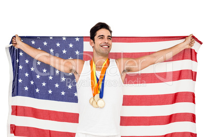 Athlete posing with gold medals after victory