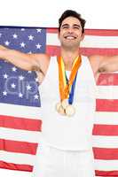 Athlete posing with gold medals after victory