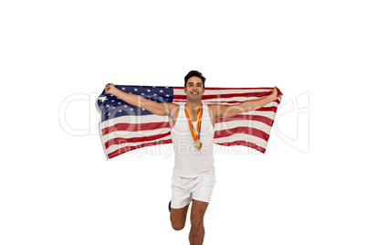 Athlete posing with gold medals and american flag after victory