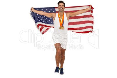 Athlete posing with gold medals and american flag after victory