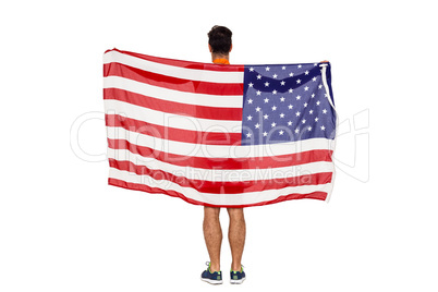 thlete posing with american flag after victory
