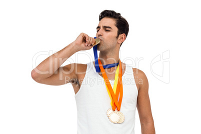 Happy athlete kissing medal