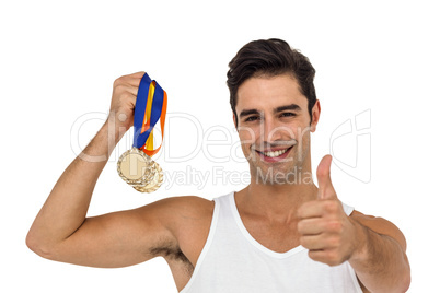 Athlete posing with gold medals