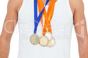 Athlete posing with gold medals around his neck