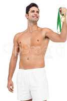 Athlete posing with gold medal on white background