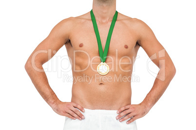 Athlete posing with gold medal on white background