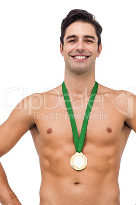 Athlete posing with gold medal on white background