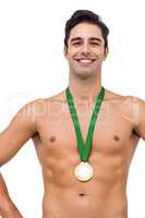 Athlete posing with gold medal on white background