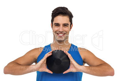 Male athlete posing with discus throw