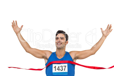 Cheerful winner athlete crossing finish line