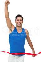 Portrait of cheerful winner athlete crossing finish line