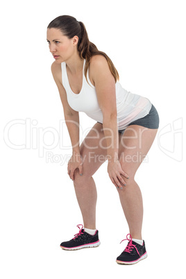 Tired athlete standing with hand on knee