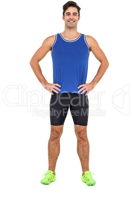 Portrait of athlete man standing with hands on hips