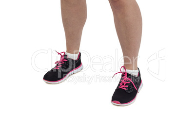 Female athlete feet standing on white background