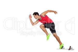 Confident male athlete running from starting blocks