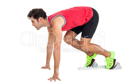 Confident male athlete in ready to run position